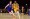 Los Angeles Lakers guard Spencer Dinwiddie (26) moves the ball ahead of Denver Nuggets guard Christian Braun  