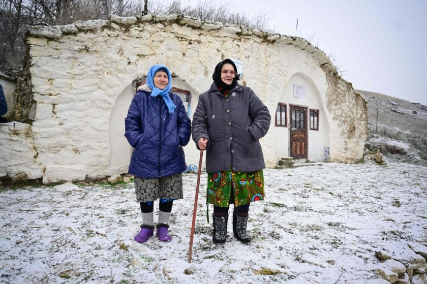 Maria Ardeleanu (L), 86, stands next to her friend outside a "basca" museum-house in Rogojeni village.