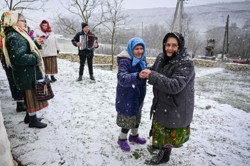 Women wearing traditional Moldovan clothes dance and ing Christmas carols in Rogojeni village